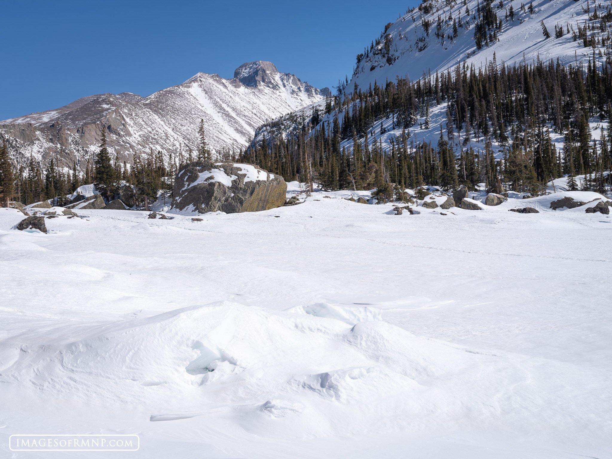 April 8, 2024 Longs Peak looks down on beautiful Lake Haiyaha on a lovely early April afternoon. The lake is still covered in deep snow, as...